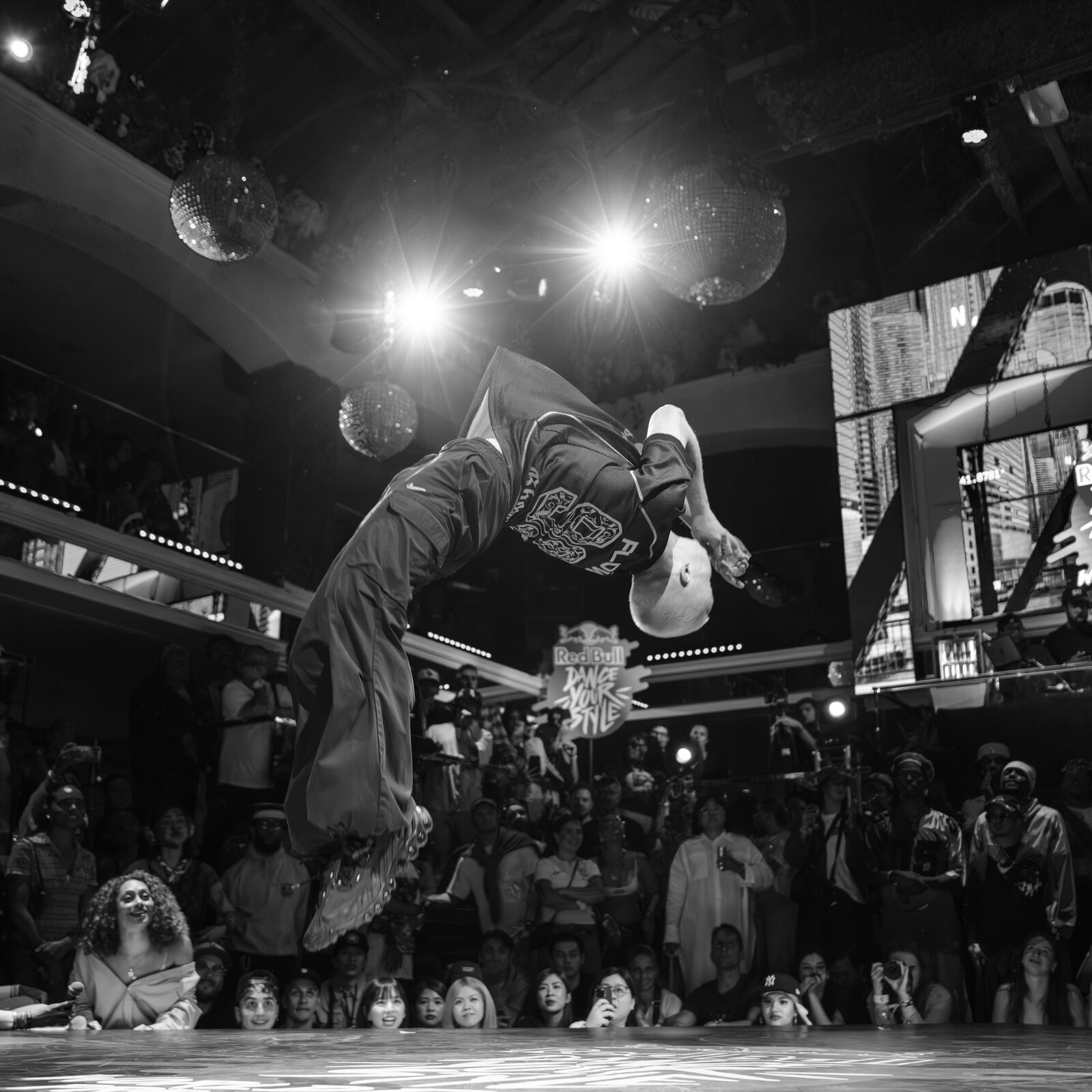 Ian Hotko mid-backflip on stage at Red Bull Dance Your Style