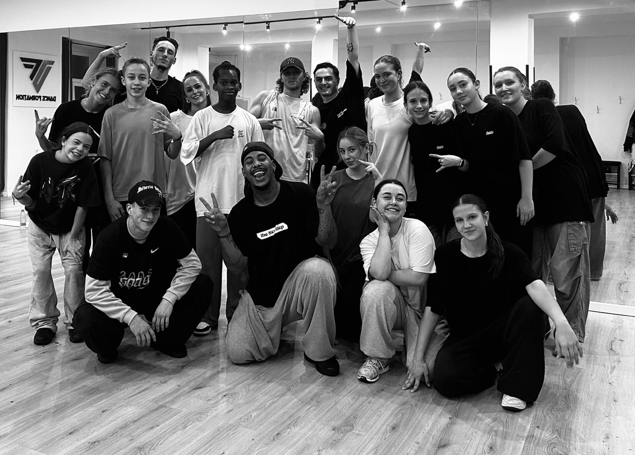 Ian Hotko with a group of dancers — community, leadership and shared passion