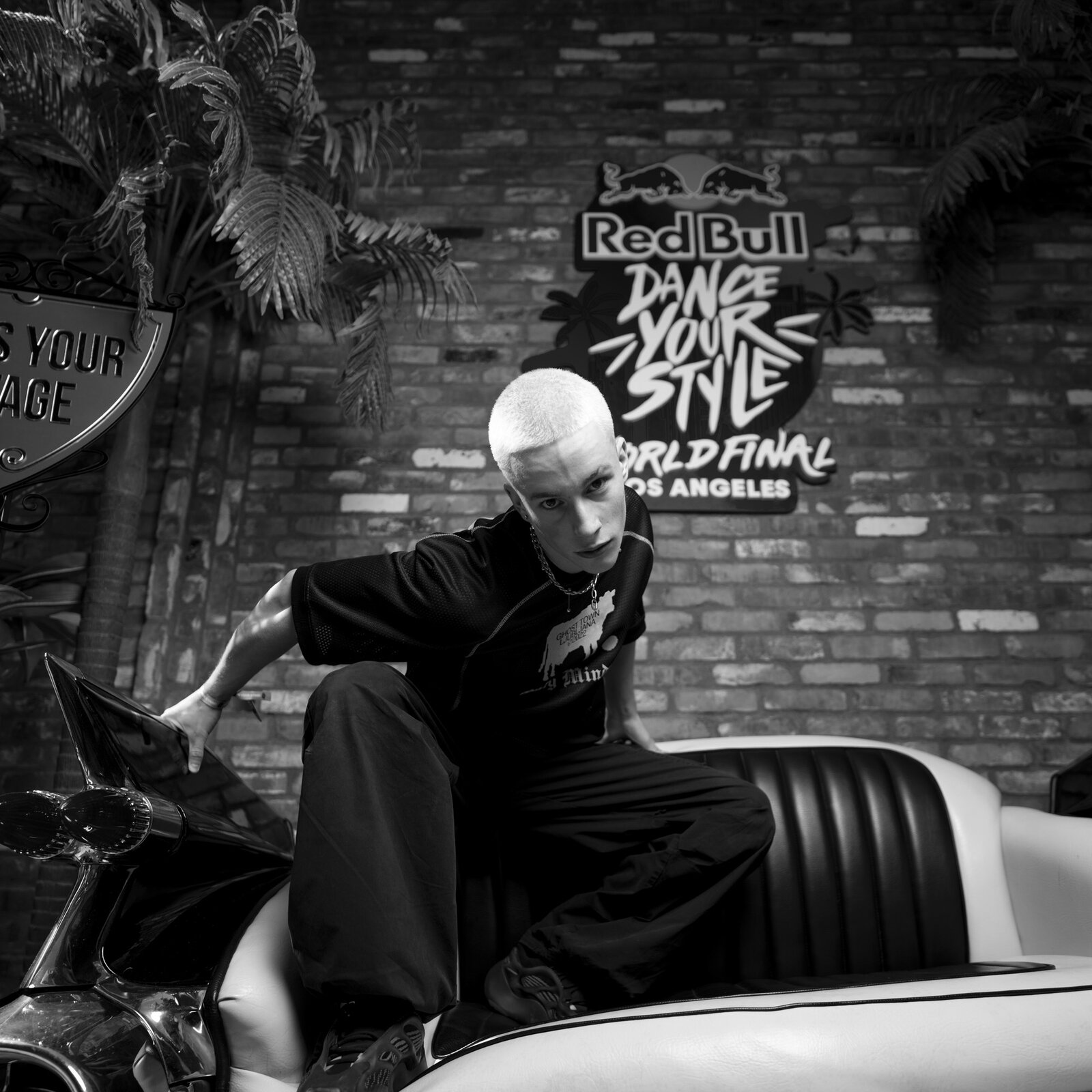 Ian Hotko posing on a Cadillac at Red Bull Dance Your Style World Final in Los Angeles